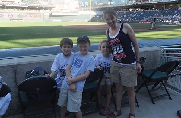 mom with children outside at a twins game