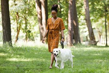 a young women walking a dog